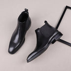 Black leather Chelsea dress boots, angled view showing side gore and block heel sole