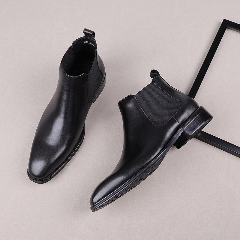 Black leather Chelsea dress boots, angled view showing side gore and block heel sole