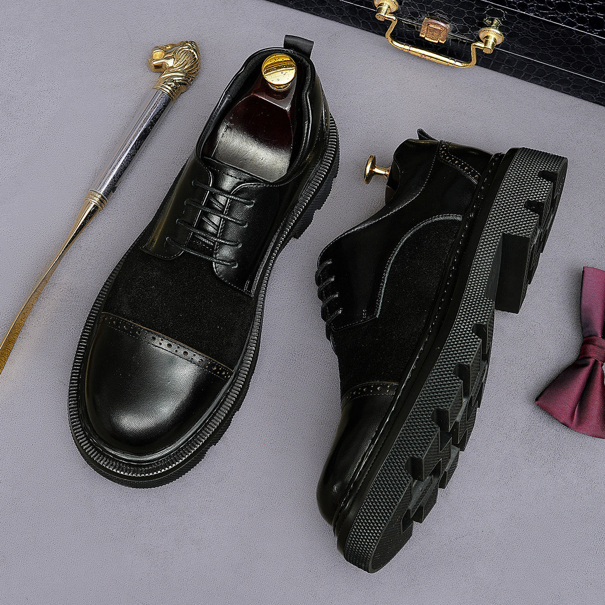 Black lace-up wingtip brogue oxfords with rugged lug outsole and side profile