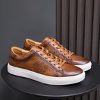 Leather sneakers in brown with tan laces, white sole, and lace-up front