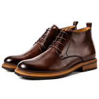 Men's dark brown leather chukka boots with plain toe, lace-up closure, and treaded sole