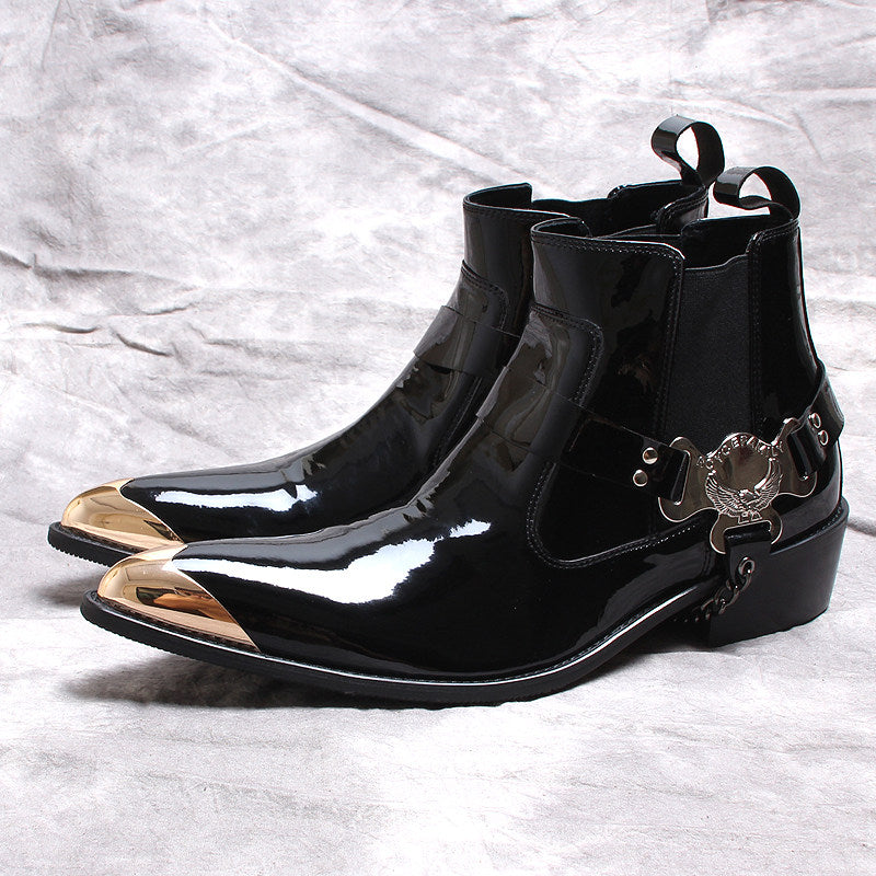 Black glossy Chelsea dress boots with slip-on gore and ornamental buckle on the side.