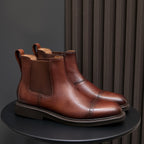 Brown pointed-toe Chelsea dress boots pair, side elastic panels and stacked rubber sole