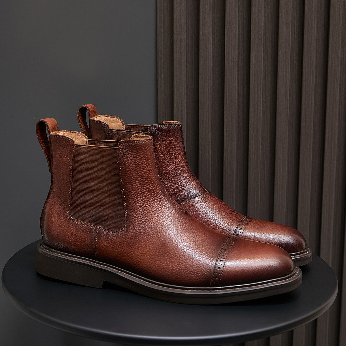 Brown pointed-toe Chelsea dress boots pair, side elastic panels and stacked rubber sole