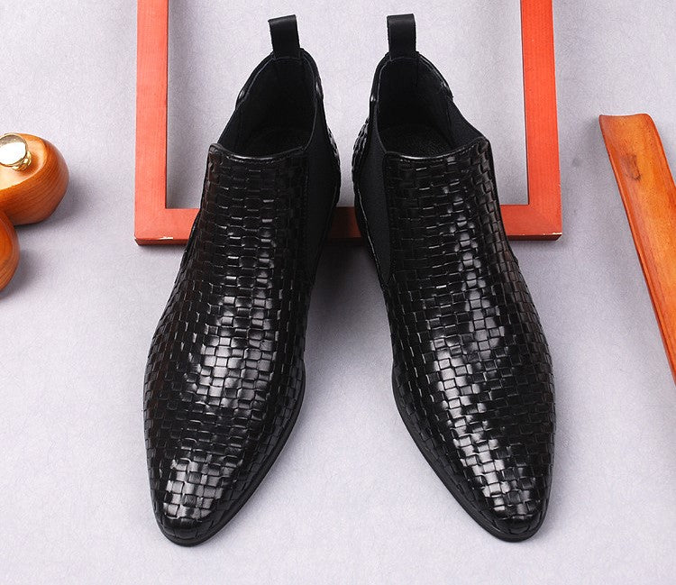Black leather dress boots with woven texture, side zipper, angled front view pair