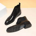Black leather Chelsea dress boots with elastic side panels; outsole visible
