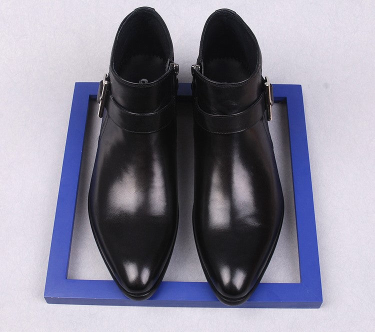 Pair of men's black leather dress boots with side zippers and thick soles.