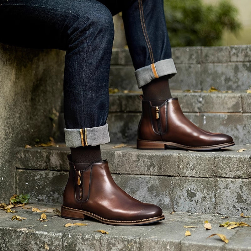 Dark brown leather pointed-toe ankle boots with side zipper and brown sole edge