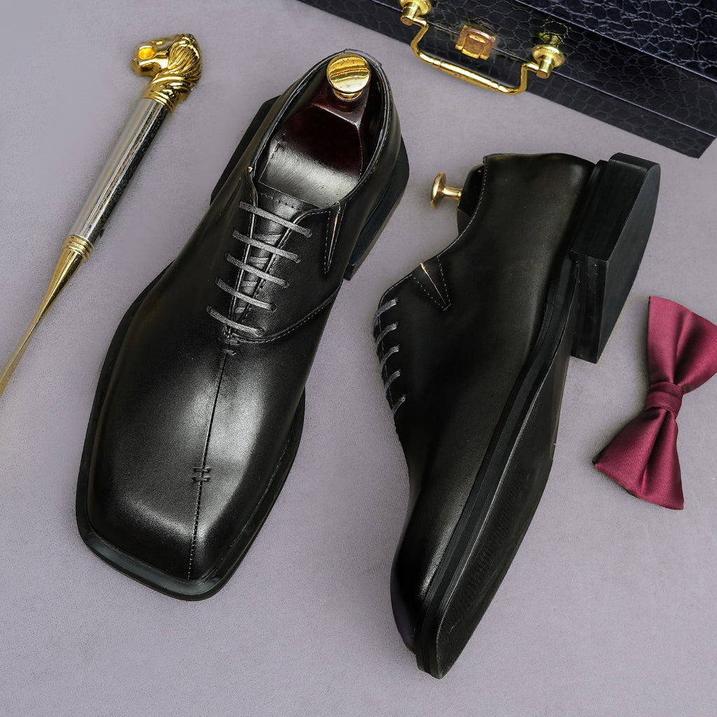 Men's chunky lug-sole wingtip brogue oxfords, black, front and side angles, lace-up.
