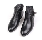 Black leather pointed-toe dress boots with side buckle strap, ankle height.
