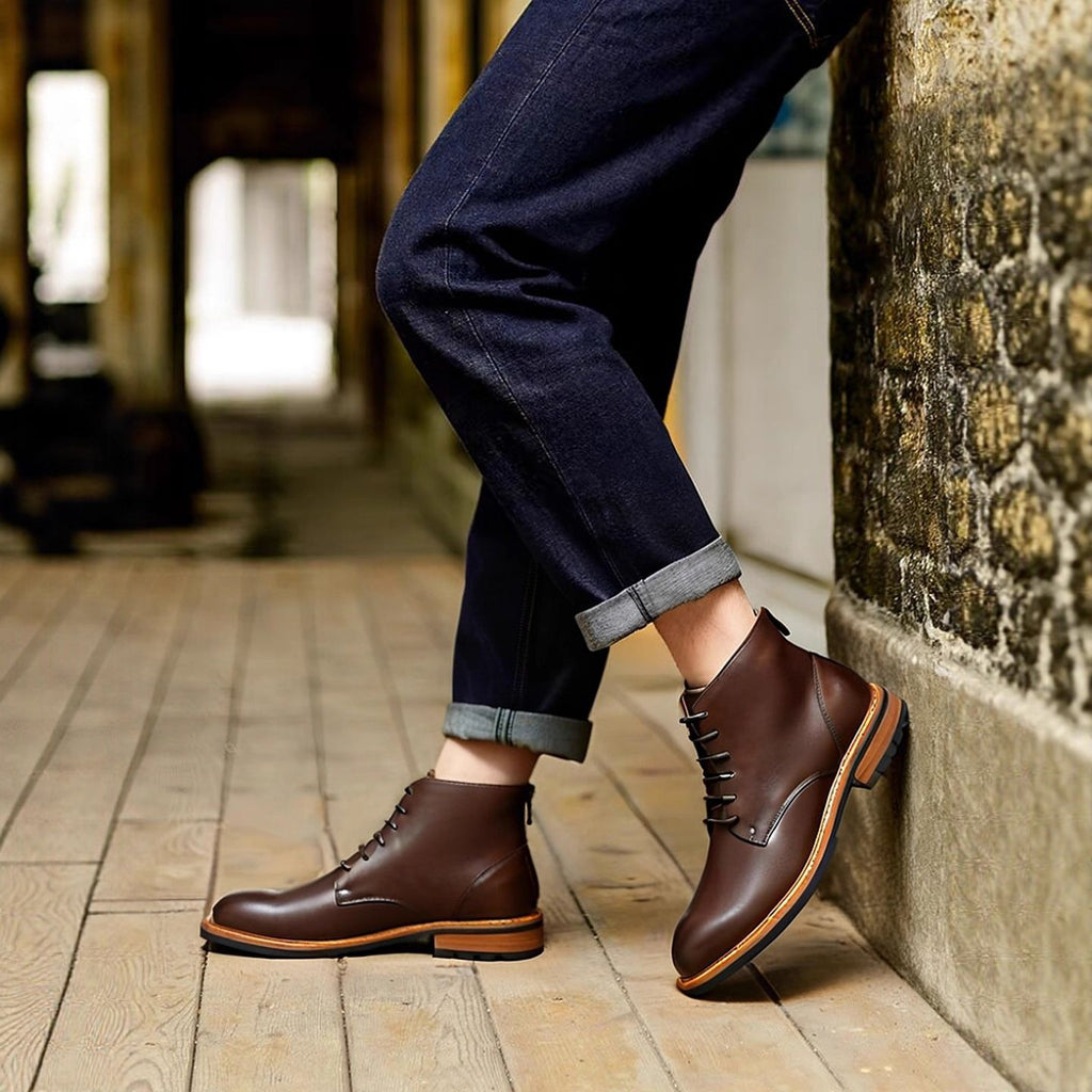 Brown leather dress boots with lace-up front and side-zip, worn with jeans