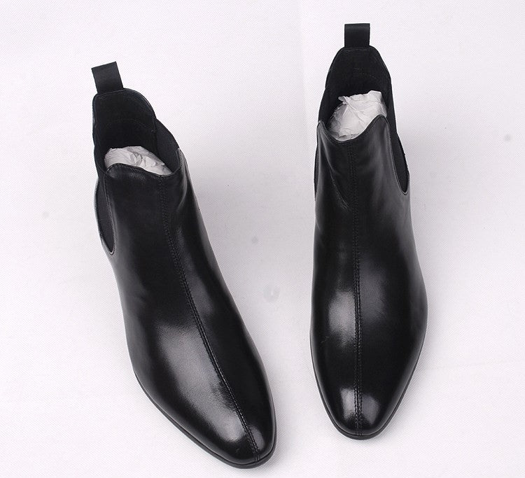 Black leather slip-on Chelsea dress boots with elastic side panels and pull tab.
