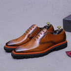 Men's brown wingtip brogue oxford shoes, 3/4 view, chunky lug sole