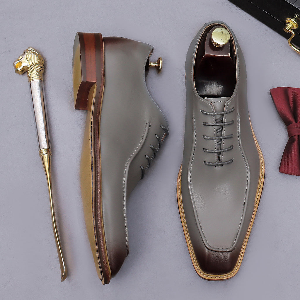 Gray chunky lug-sole brogue Oxford shoe with dark brown outsole, side profile