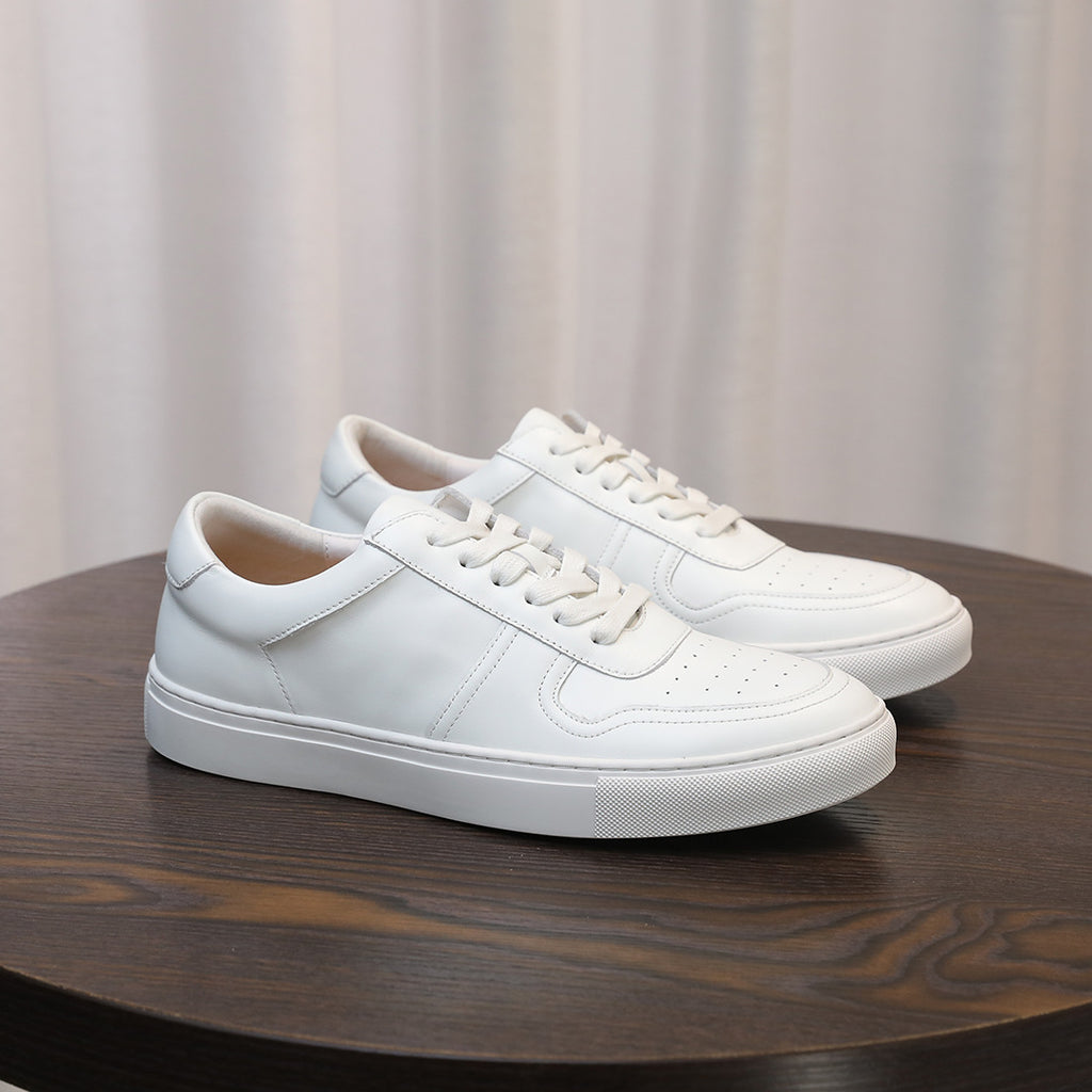White men's leather sneakers, side view, lace-up design with stitched panels