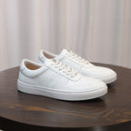 White men's leather sneakers, side view, lace-up design with stitched panels
