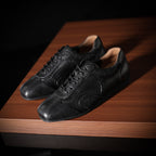 Men's black leather sneakers with lace-up design and textured toe and sides