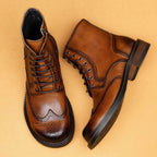 Brown leather lace-up ankle boots with wingtip perforations and thick rubber outsole