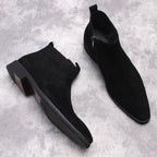 Black suede side-zip boots with thick block heels and soles, side-angle view.