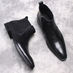 Men's black leather ankle boots with side zip and thick sole, overhead pair view