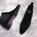 Black Chelsea dress boots: one suede and one smooth leather, side elastic gore