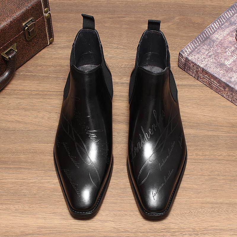 Pair of black leather Chelsea dress boots with elastic gore and low-profile heel