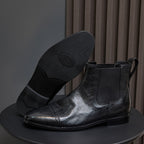Men's black pointed-toe Chelsea dress boots with elastic side panels and pull tabs