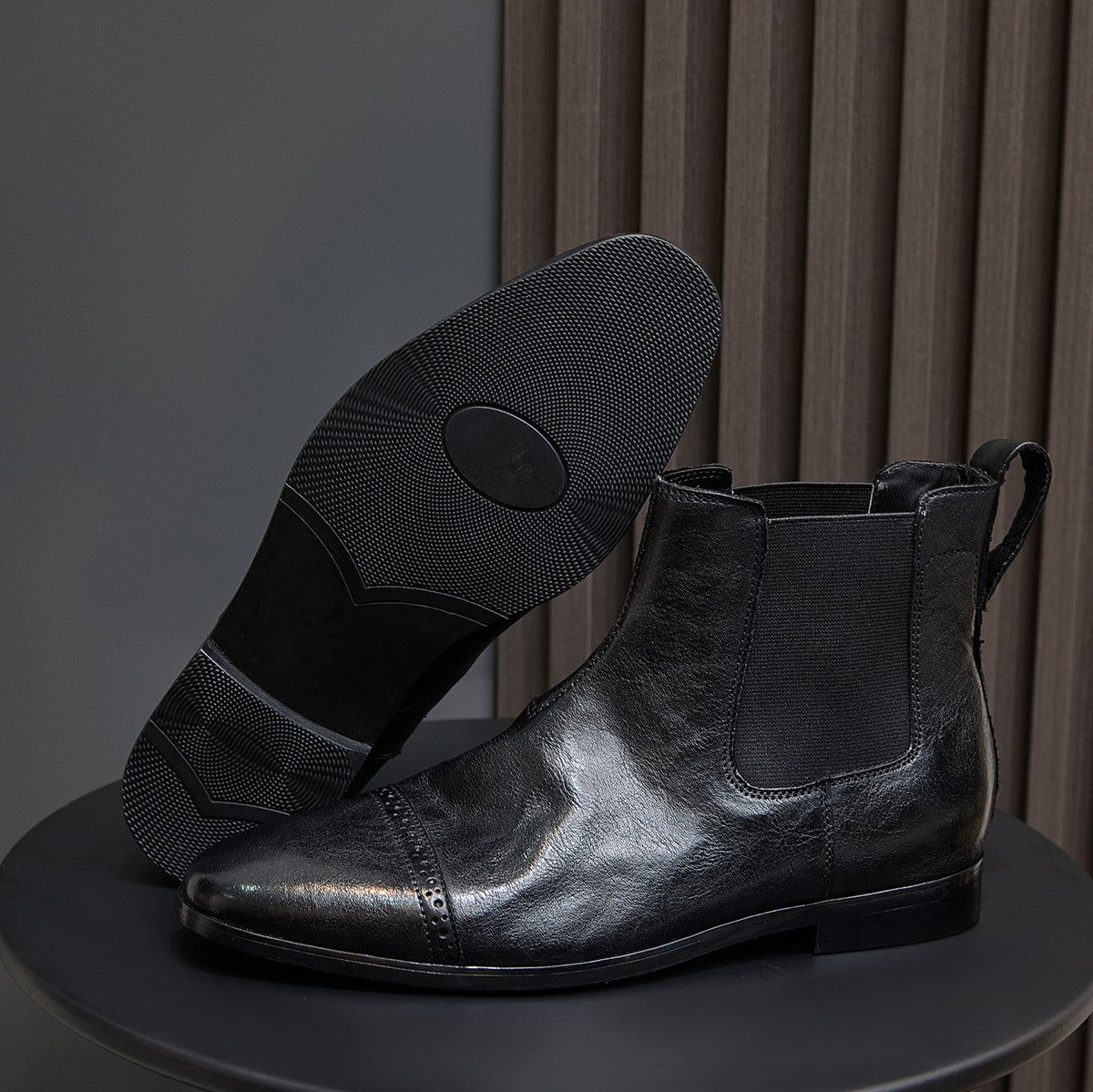 Men's black pointed-toe Chelsea dress boots with elastic side panels and pull tabs