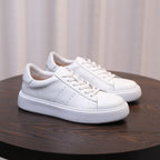 Men's leather sneakers, white, front view with lace-up closure and stitched leather panels