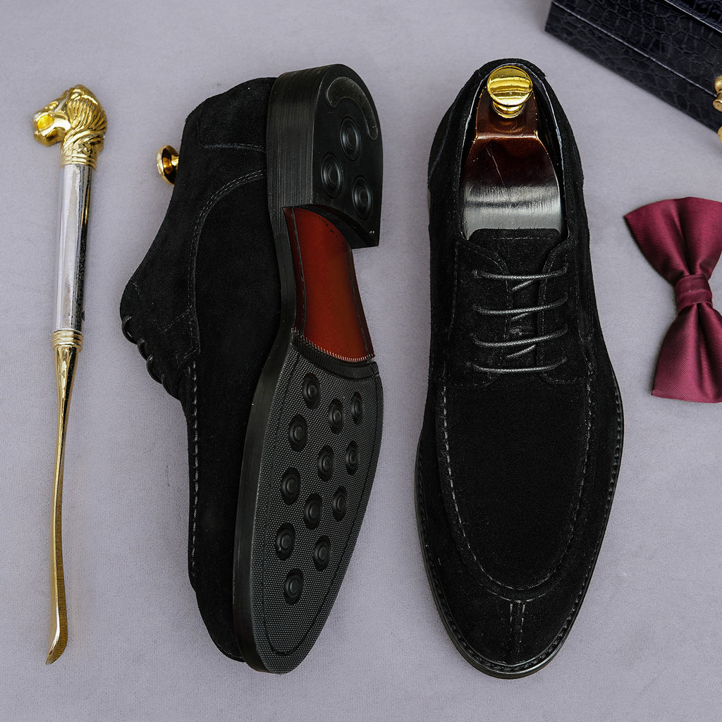 Men's black Oxford shoes showing chunky lug soles and lace-up design