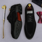 Men's black Oxford shoes showing chunky lug soles and lace-up design