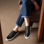 Men's black leather lace-up sneakers with low-profile white sole