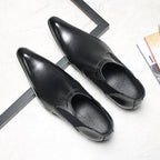 Men's black leather Chelsea dress boots, showing curved toe and elastic side gore