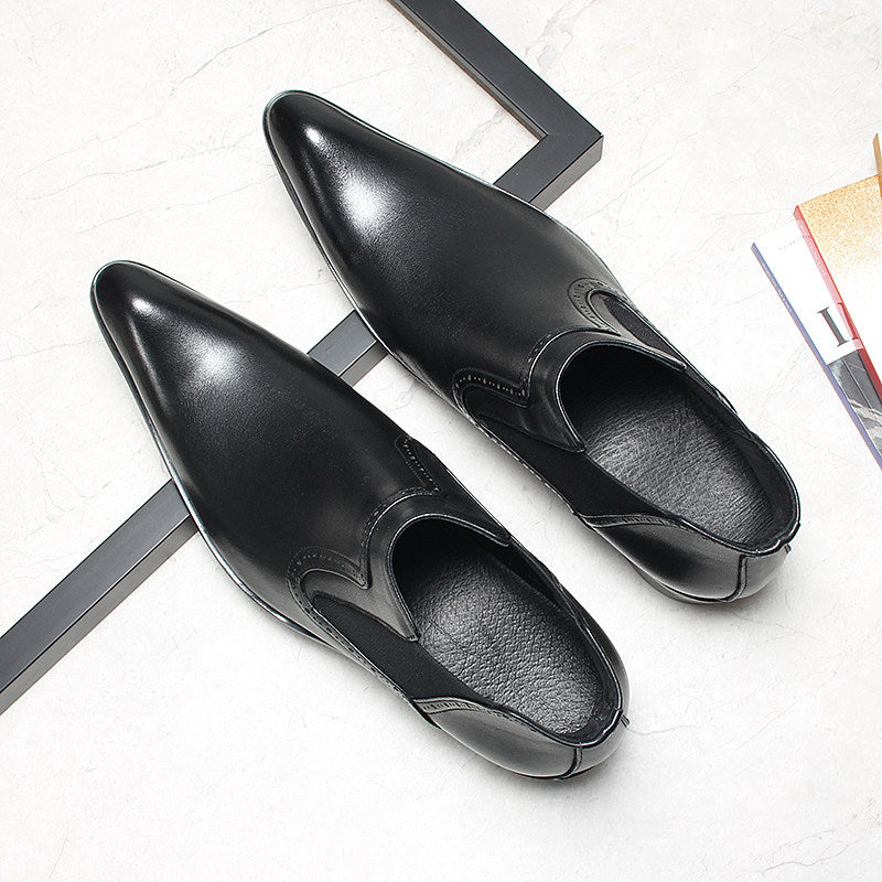 Men's black leather Chelsea dress boots, showing curved toe and elastic side gore