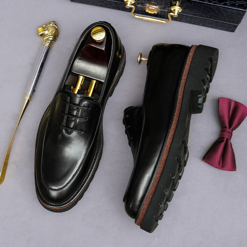 Men's chunky lug-sole wingtip oxfords, black pair shown from top and side
