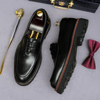 Men's chunky lug-sole wingtip oxfords, black pair shown from top and side