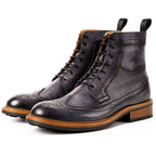 Men's dark leather chukka boots with lace-up closure and perforated toe