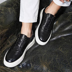 Men's black leather sneakers with lace-up design and thick white rubber sole
