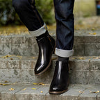 Black leather pointed-toe ankle boots with side zipper and low stacked sole