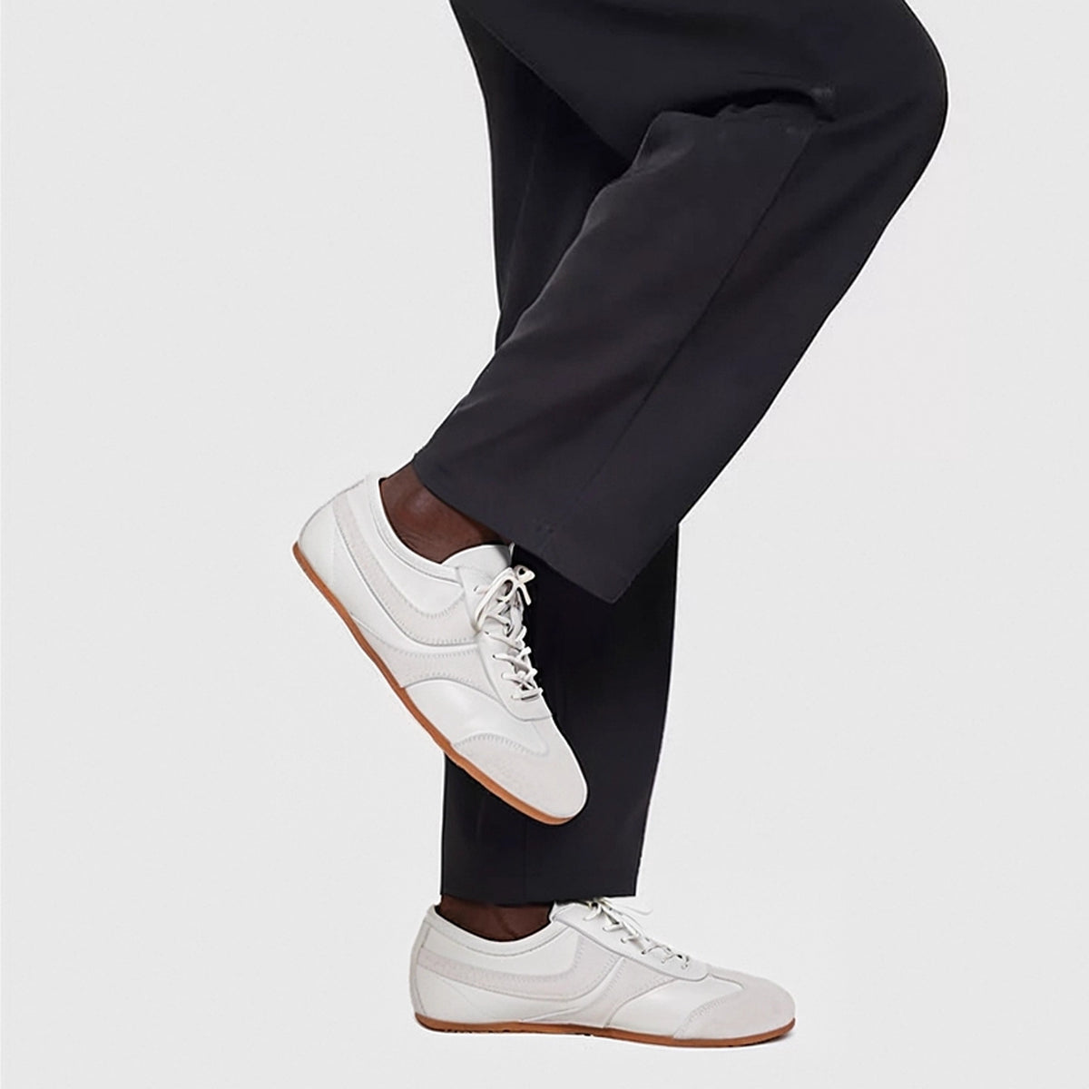 Men's white leather sneakers with lace-up closure and minimal side stitching