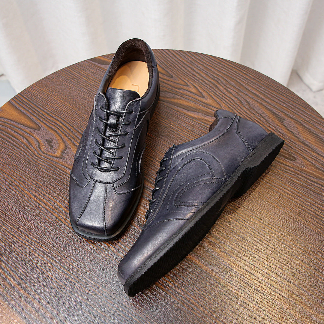 Men's dark gray leather sneakers, lace-up style with side stitching and rubber outsole