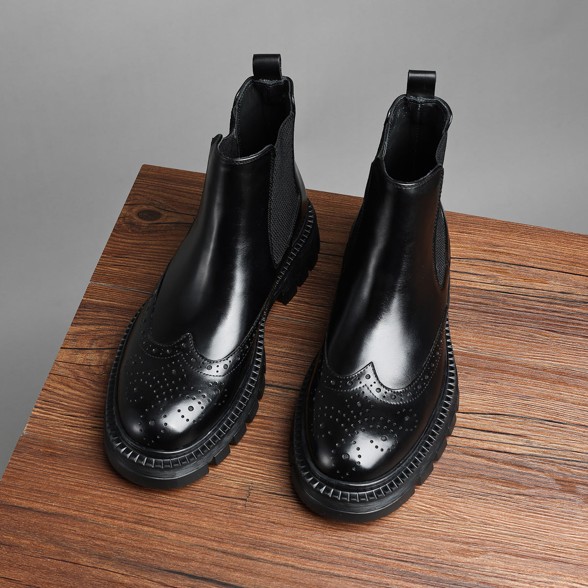 Black leather chelsea dress boots with elastic side panels, brogue detailing, chunky sole