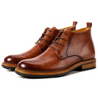 Men's brown leather chukka boots with plain toe, lace-up front, and thick treaded sole