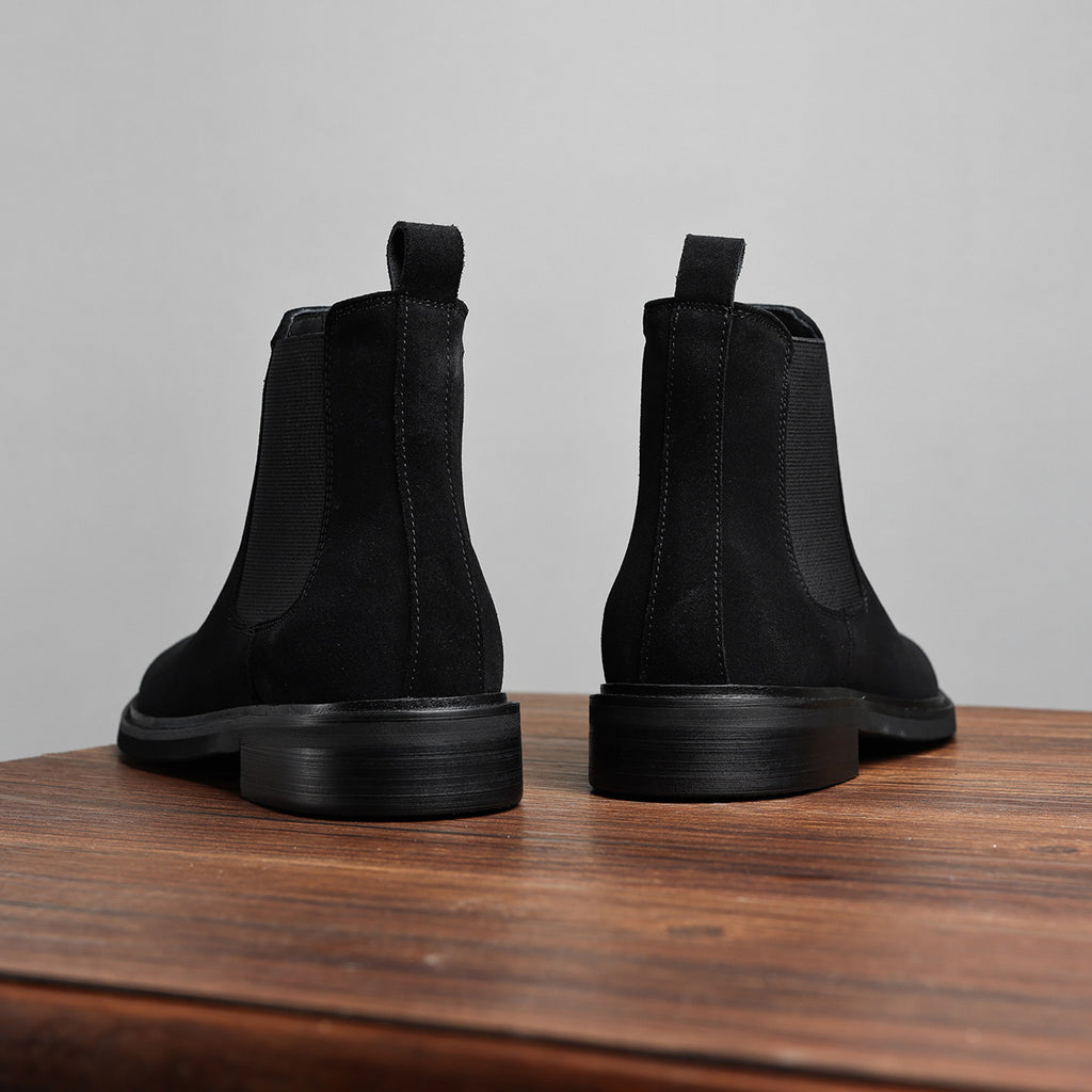 Black Chelsea dress boots rear view with stacked heel and side elastic panels.