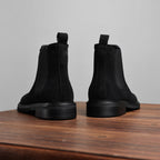 Black Chelsea dress boots rear view with stacked heel and side elastic panels.