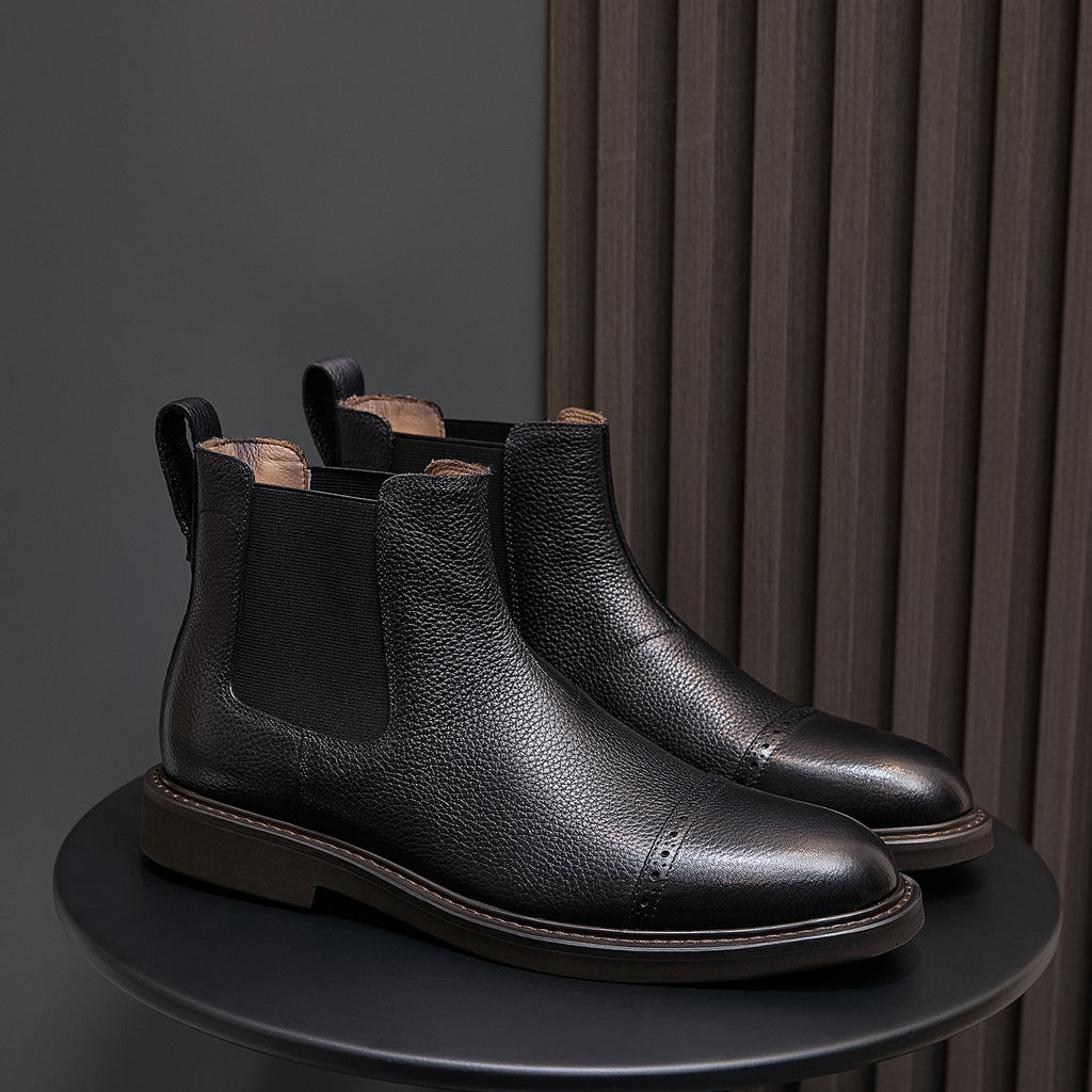 Black pointed-toe Chelsea dress boots pair, side elastic panels and low stacked heel