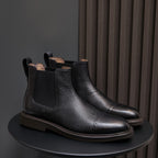 Black pointed-toe Chelsea dress boots pair, side elastic panels and low stacked heel