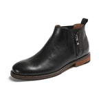 Black leather side-zip ankle boots with pointed toe and brown sole trim