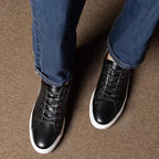 Men's black leather lace-up sneakers with white sidewall sole