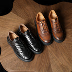 Men's leather sneakers set on wood: black pair and brown pair, lace-up style.